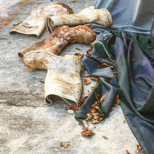 white boots covered with mud and dirt